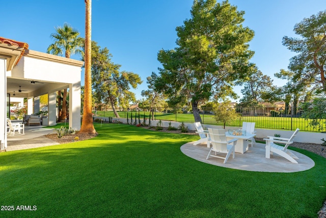 view of yard featuring a patio area and ceiling fan