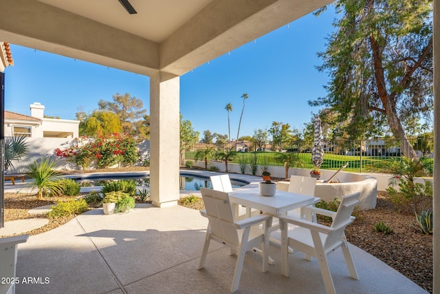 view of patio / terrace featuring ceiling fan and a fenced in pool