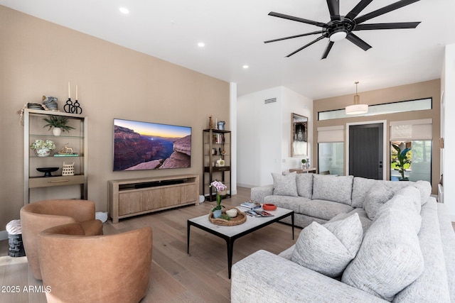 living room with ceiling fan and hardwood / wood-style floors