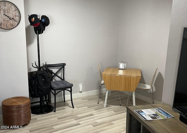 dining space featuring baseboards and wood finished floors