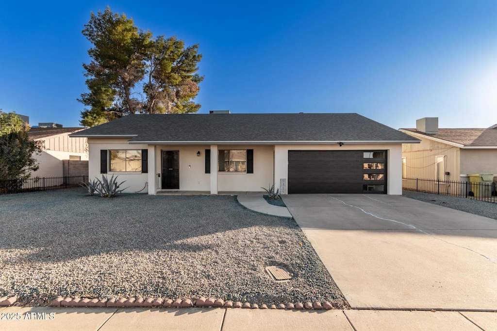 view of front of property featuring a garage and central air condition unit