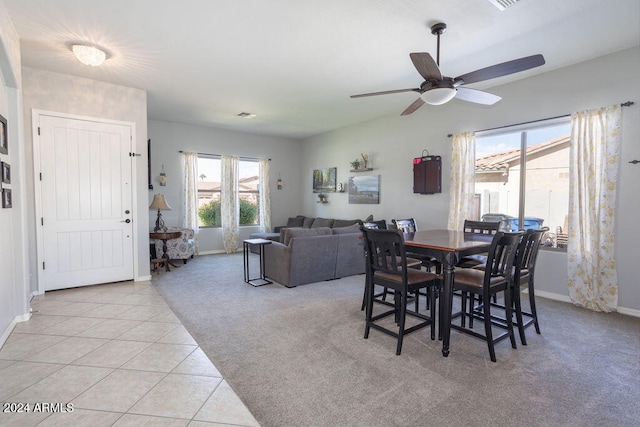 carpeted dining room featuring ceiling fan and a wealth of natural light