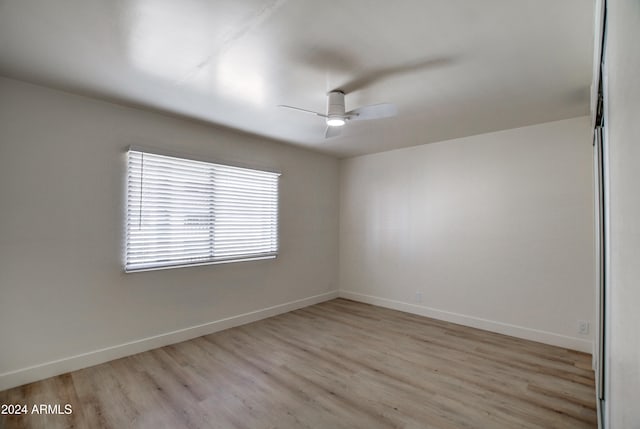 spare room featuring ceiling fan and light hardwood / wood-style floors