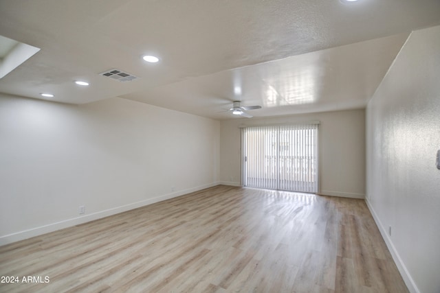 unfurnished room with light wood-type flooring and ceiling fan