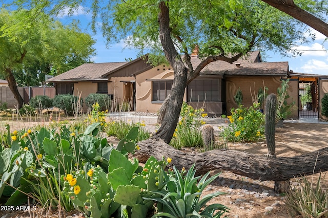 1720 W Elm St, Phoenix, AZ 85015 - view of front of home featuring stucco siding, fence, and roof with shingles