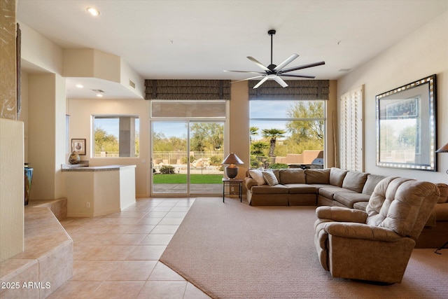 living area with recessed lighting, light tile patterned flooring, a ceiling fan, and a healthy amount of sunlight