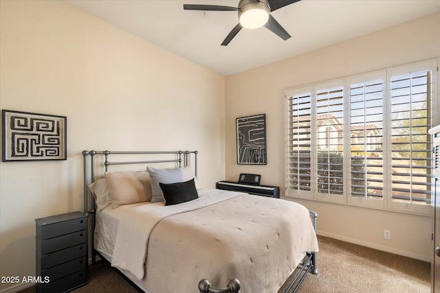 carpeted bedroom with ceiling fan and baseboards