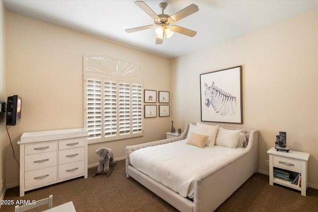 bedroom featuring dark carpet, a ceiling fan, and baseboards