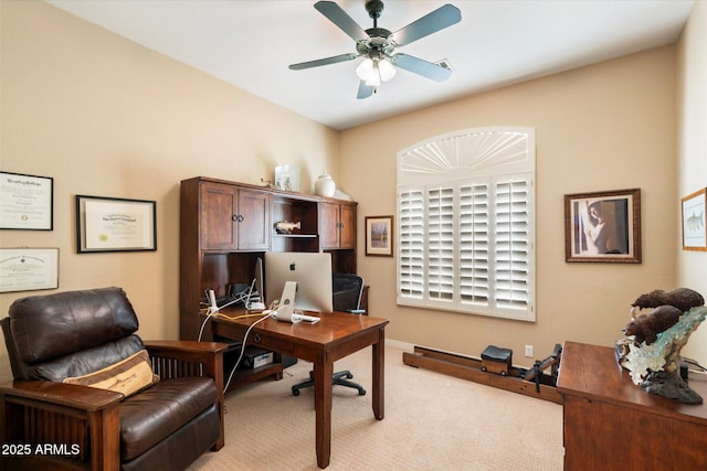 home office with a ceiling fan and light colored carpet