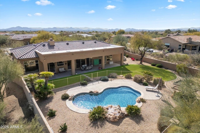 view of swimming pool with a fenced in pool, a patio area, a fenced backyard, and a mountain view