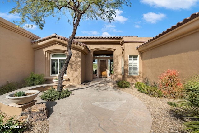 entrance to property with stucco siding