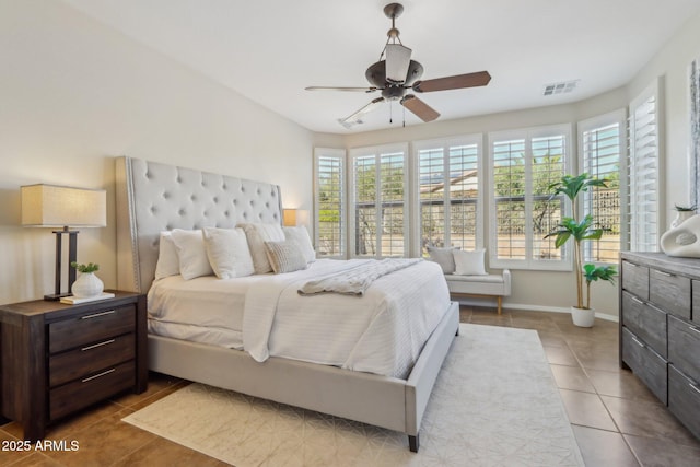 tiled bedroom with ceiling fan