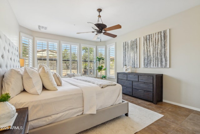 bedroom featuring multiple windows, light tile patterned floors, and ceiling fan