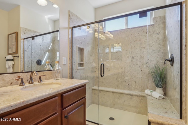 bathroom featuring vanity and an enclosed shower