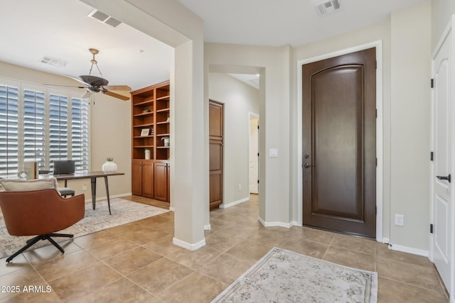 entryway featuring light tile patterned floors and ceiling fan