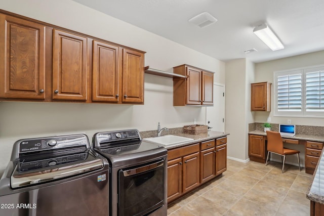 laundry area featuring sink, light tile patterned floors, cabinets, and independent washer and dryer