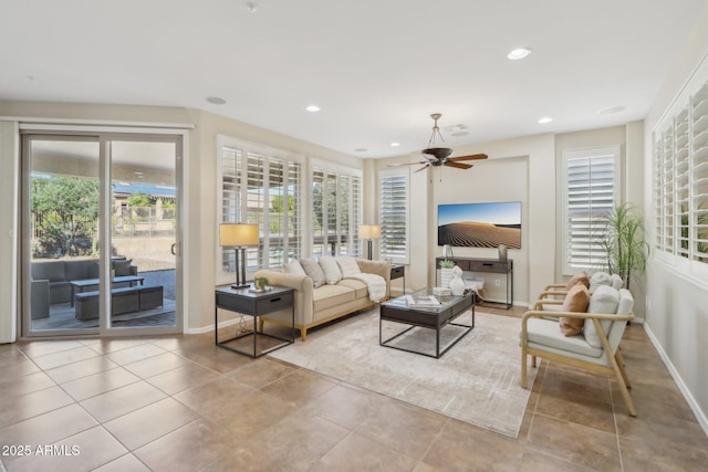 living room featuring ceiling fan, a healthy amount of sunlight, and light tile patterned floors