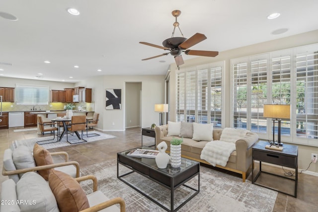 living room featuring sink, light tile patterned floors, and ceiling fan