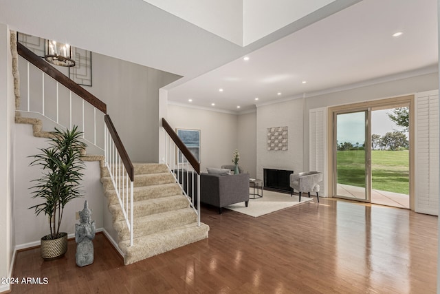 interior space with a chandelier, hardwood / wood-style floors, and crown molding