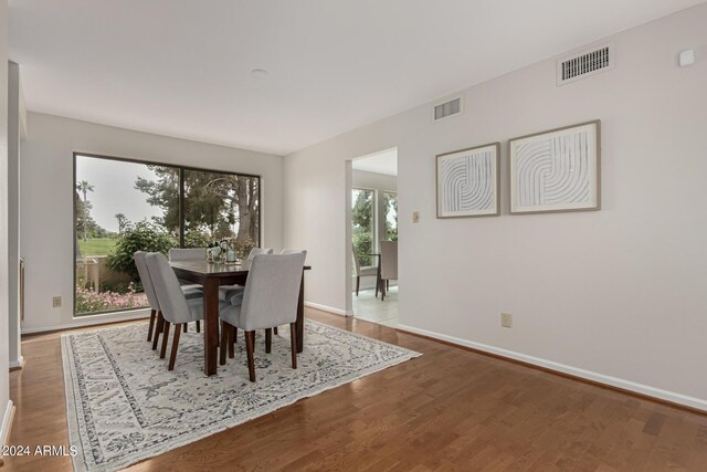 dining space with wood-type flooring