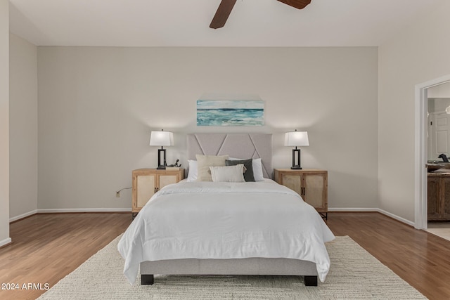 bedroom featuring wood-type flooring, ceiling fan, and ensuite bathroom