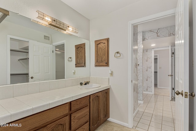 bathroom featuring a shower with shower curtain, tile patterned flooring, and vanity