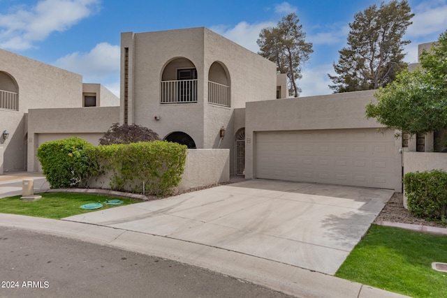 adobe home with a balcony and a garage