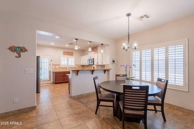 1927 W Mine Trl, Phoenix, AZ 85085 - dining space featuring a chandelier, light tile patterned flooring, and recessed lighting
