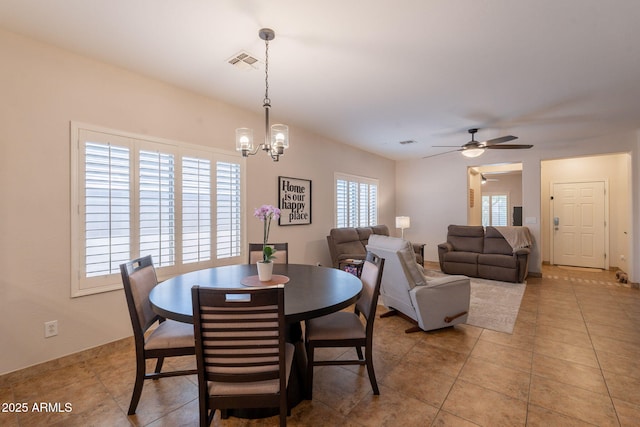 1927 W Mine Trl, Phoenix, AZ 85085 - dining room with ceiling fan, light tile patterned floors, and a chandelier