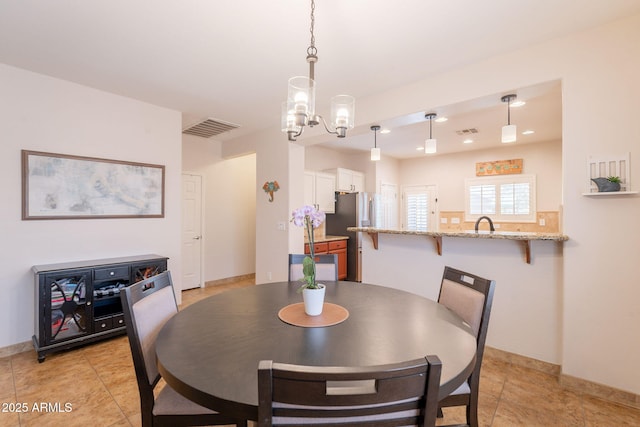 1927 W Mine Trl, Phoenix, AZ 85085 - dining space featuring a chandelier and light tile patterned flooring