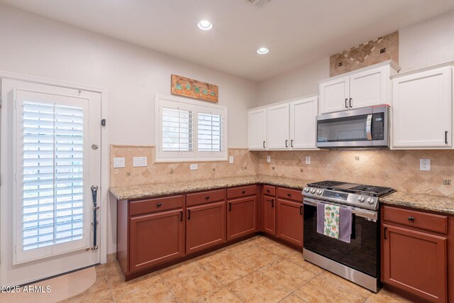 1927 W Mine Trl, Phoenix, AZ 85085 - kitchen featuring stainless steel appliances, decorative backsplash, white cabinetry, light stone countertops, and recessed lighting
