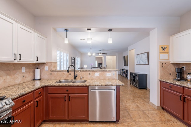 1927 W Mine Trl, Phoenix, AZ 85085 - kitchen with appliances with stainless steel finishes, a peninsula, decorative backsplash, white cabinetry, and decorative light fixtures