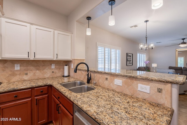 1927 W Mine Trl, Phoenix, AZ 85085 - kitchen featuring ceiling fan, a peninsula, decorative backsplash, light stone counters, and hanging light fixtures