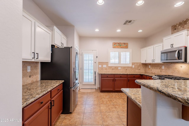 1927 W Mine Trl, Phoenix, AZ 85085 - kitchen featuring stainless steel appliances, white cabinets, backsplash, light stone counters, and recessed lighting