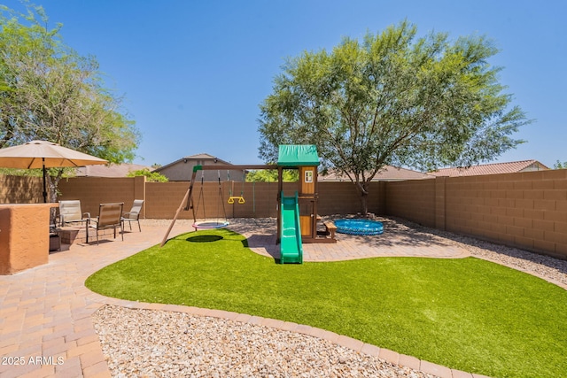 1927 W Mine Trl, Phoenix, AZ 85085 - fenced backyard with a playground and a patio area