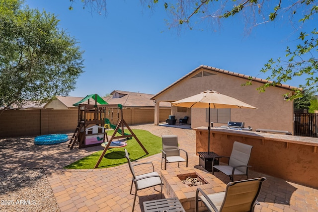 1927 W Mine Trl, Phoenix, AZ 85085 - fenced backyard with a patio area, an outdoor fire pit, a playground, and area for grilling