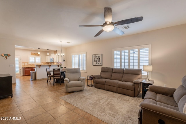 1927 W Mine Trl, Phoenix, AZ 85085 - living area with light tile patterned floors, a ceiling fan, plenty of natural light, and a chandelier