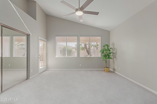 unfurnished room with ceiling fan, light carpet, and lofted ceiling