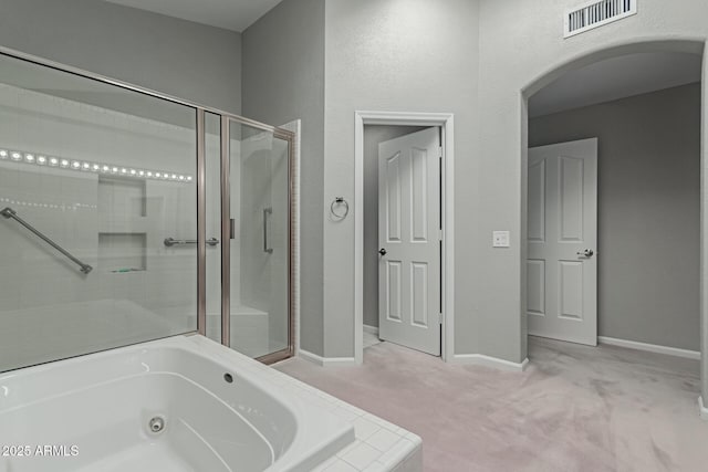 bathroom featuring shower with separate bathtub