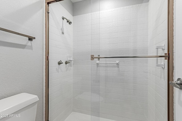 bathroom featuring toilet and walk in shower