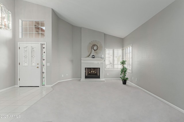 unfurnished living room featuring light tile patterned floors, lofted ceiling, and a fireplace