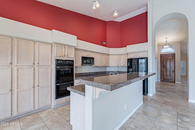 15809 S 31st St, Phoenix, AZ 85048 - kitchen with black appliances, a towering ceiling, arched walkways, a center island with sink, and tile countertops