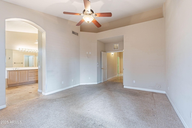 15809 S 31st St, Phoenix, AZ 85048 - unfurnished room featuring arched walkways, light carpet, a ceiling fan, and baseboards