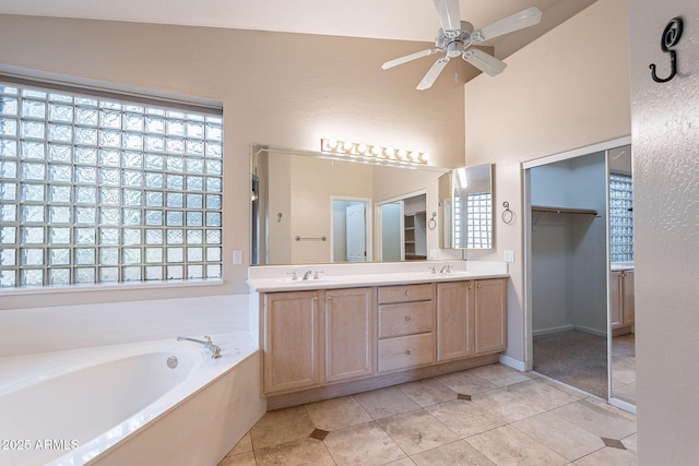 15809 S 31st St, Phoenix, AZ 85048 - bathroom featuring double vanity, a bath, ceiling fan, tile patterned floors, and a walk in closet