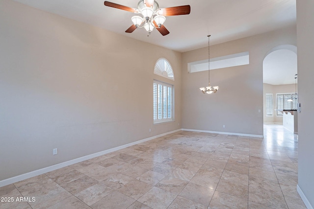 15809 S 31st St, Phoenix, AZ 85048 - unfurnished room featuring arched walkways, a ceiling fan, baseboards, and a chandelier