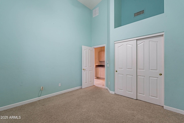 15809 S 31st St, Phoenix, AZ 85048 - unfurnished bedroom featuring high vaulted ceiling, light carpet, baseboards, and a closet