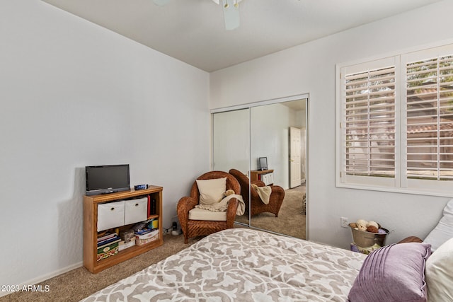 bedroom with carpet floors, ceiling fan, and a closet