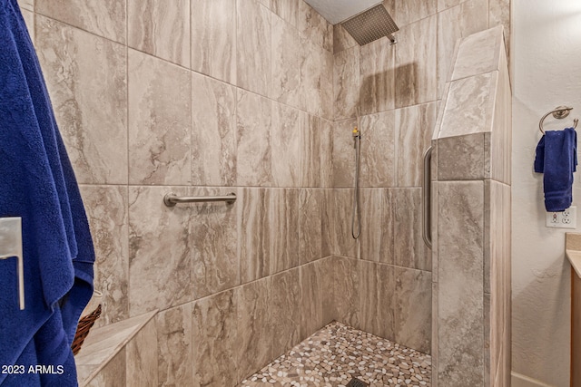 bathroom with a tile shower