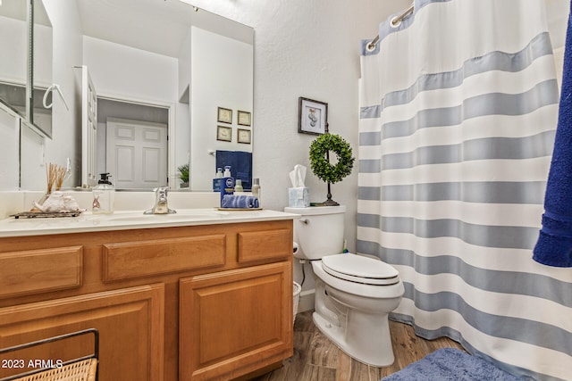 bathroom featuring hardwood / wood-style floors, vanity, and toilet