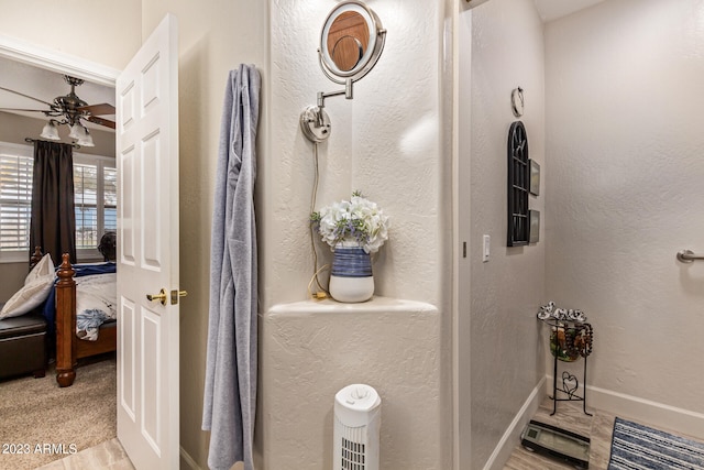 bathroom featuring ceiling fan and hardwood / wood-style flooring